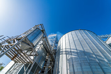 Special grain elevators for crop storage. Metal bridge from the roof of metal tank. View from below. Closeup.