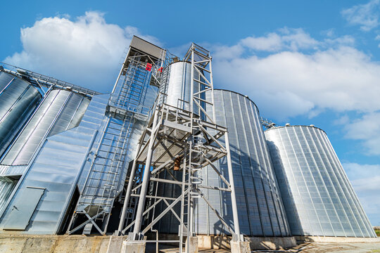 View from below on steel grain elevators. Modern up to date factory. Selective focus.