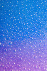 Water droplets on blue glass