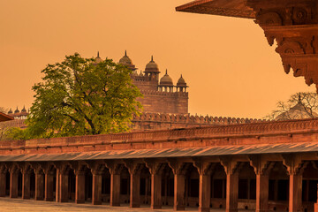 Fototapeta premium The western side of the abandoned temple complex walls at Fathepur Sikri, India glows after sunset