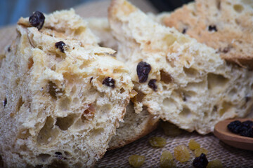 panettone soft bread with raisin. rustic background with christmas ornament