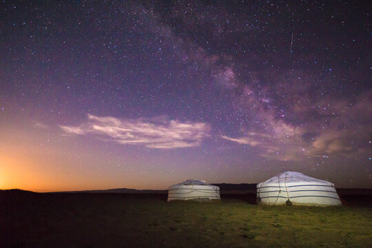 Scenic view of milky way over ger camps on landscape