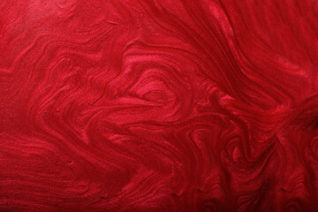 Red shimmer and glitter abstract background. Make up concept.Beautiful stains of liquid nail...