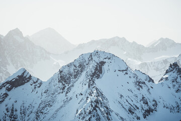 Fototapeta premium Snow mountain landscape with a sommet with mountaineers around a cross