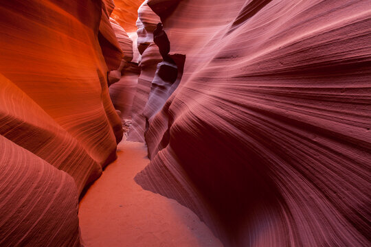 Scenic view of sunlight passing through narrow path between Lower Antelope Canyon