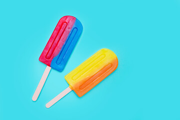 Lollipop on light blue background. Bright summery background with popsicles. 
