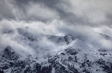 snowy mountain peaks in clouds