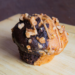 chocolate and cream muffin with pieces of nuts and caramel