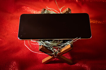 Religion crisis - digital Christmas - mobile phone in the manger