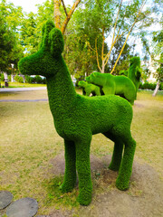 Green faux fur deer figure in the Park.