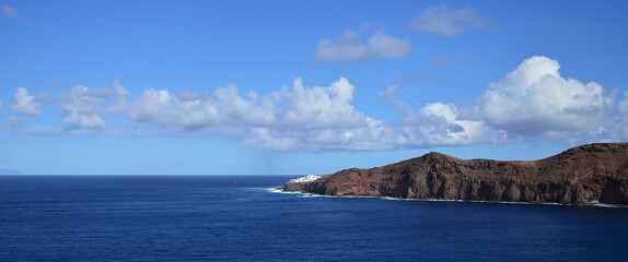 Panoramic image with calm sea, intense blue sky and low clouds, coast of Sardina, Galdar,  Gran Canaria