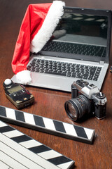 notbook next to a clapperboard. camera and handheld photometer, cell phone on wood in zenith plane...