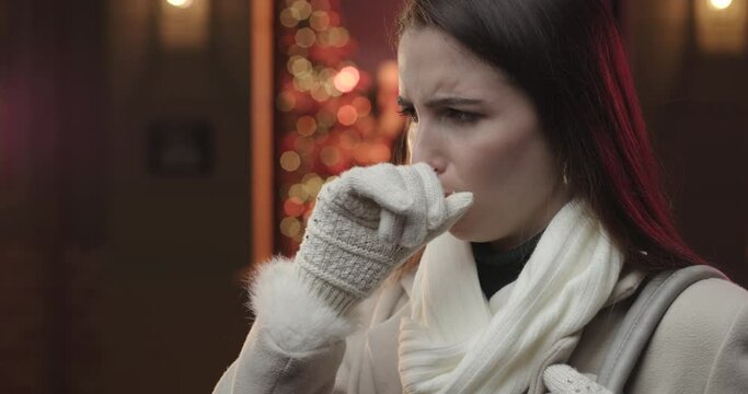Young woman coughing.