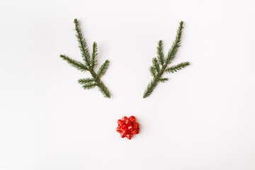 Christmas, winter, new year composition. Creative reindeer made of Fir branches with red decoration...