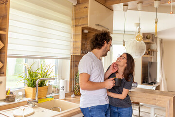 Couple drinking morning coffee in the kitchen