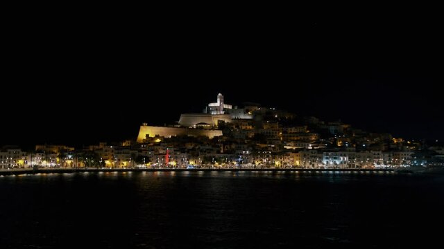 Ibiza old town castle Dalt Vila at night from a ship