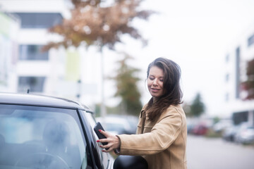young woman using a car as carsharing