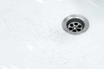 Hair loss. Hair in the sink after combing the head