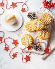 Christmas or New Year homemade sweet present mini cakes with icing sugar. Festive decoration. Flat lay, top view.