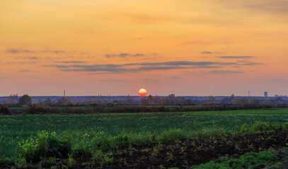 Sunset, the sun sets over the horizon, rural landscape.