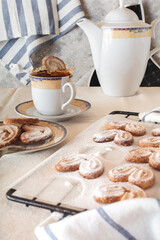 The cookie falls into a cup of tea. Selective focus.