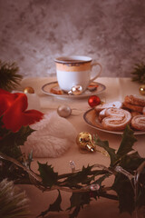 Santa hat, Christmas toys and puff cookies on the table. Shallow depth of field, selective focus to the foreground
