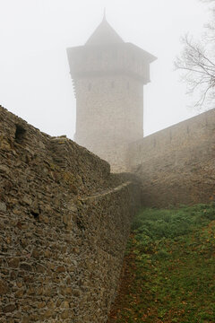 old tower of medieval Helfstyn fortress in Czech republic in autumn morning mist
