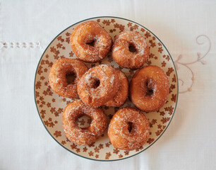 freshly baked homemade donuts on a plate, high view
