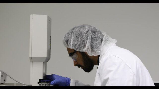 scientist looking to sample in a laboratory with spectrometer