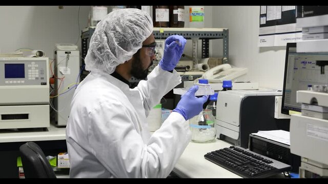 scientist looking to sample in a laboratory with spectrometer