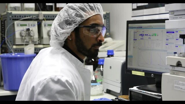 scientist looking to sample in a laboratory with spectrometer