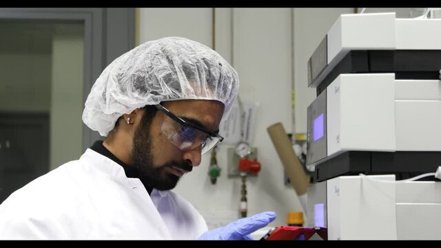 scientist looking to sample in a laboratory with spectrometer
