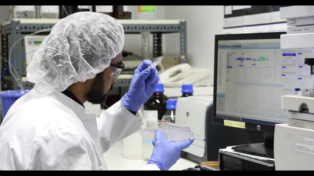 scientist looking to sample in a laboratory with spectrometer