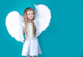Saint Valentines Day card. Child wearing long white dress and angel wings. Happy angel girl over...