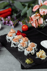 Felix roll with tuna wasabi sauce and pickled ginger on a black board