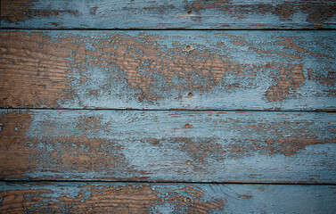 Natural wood background with peeling blue paint
