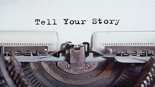 Vintage typewriter with text related to marketing, business or finance. Inscription Tell Your Story