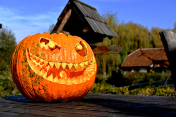Halloween pumpkin on wood in a spooky village