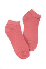Pair of pink short socks on white background, top view