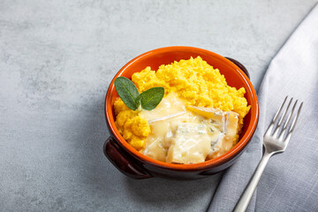Dish of polenta with melted gorgonzola cheese