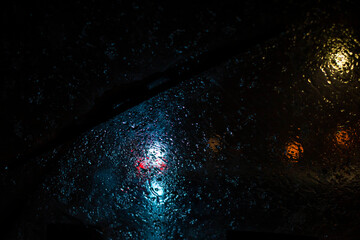poor visibility through wet windscreen while driving car on street in Moscow city in winter evening