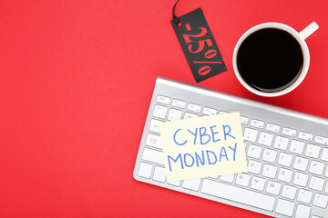 Inscription Cyber Monday with keyboard, cup of coffee and sale tag on red background
