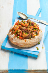 Goulash served in a bread bowl, a traditional beef stew of the Hungarian cuisine.