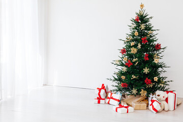 Christmas tree with decorations and gifts interior of the house new holiday white