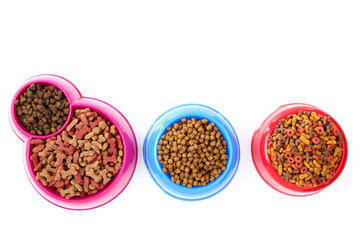Dry pet food in bowls isolated on white background