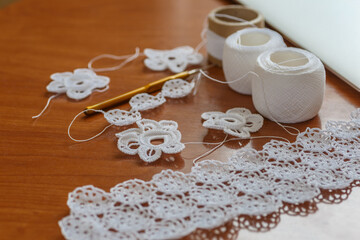 Fototapeta na wymiar Crochet knitting. Lace of flowers. Handmade Irish lace as a background