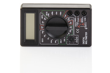 Digital electrical tester multimeter in black case isolated on white background. Digital multimeters have a numeric display, can measure voltage, current and resistance. Close-up.