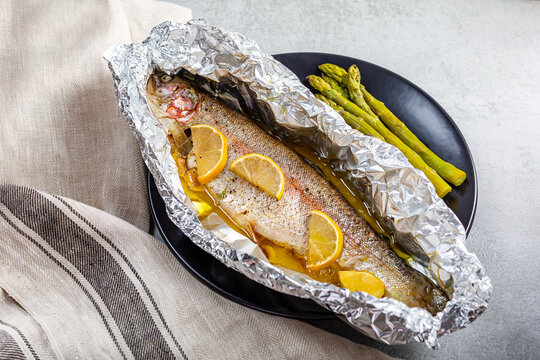 Fresh baked salmon trout in an aluminum foil