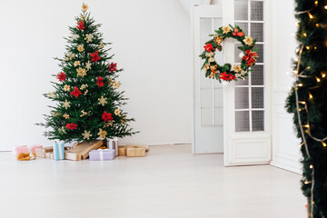 Christmas tree with decorations and gifts interior of the house new holiday white