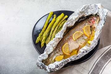 Fresh baked salmon trout in an aluminum foil